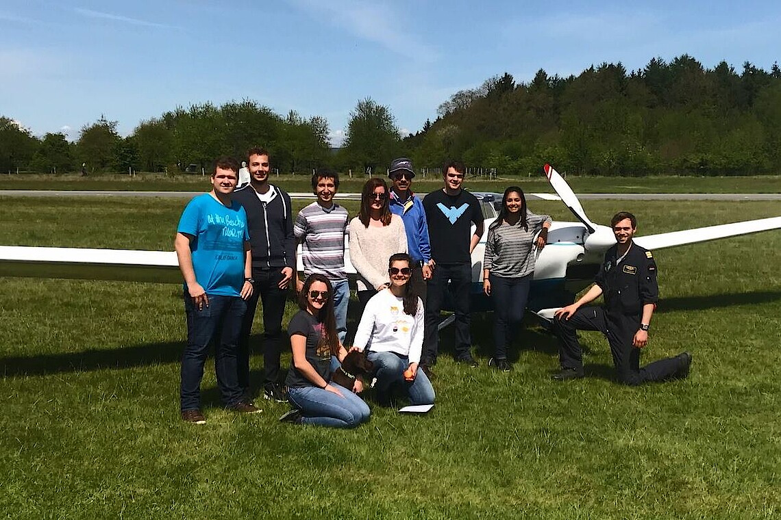 Students and professor with light aircraft