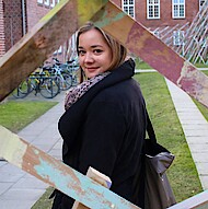 
                                Female student standing on campus 
                            