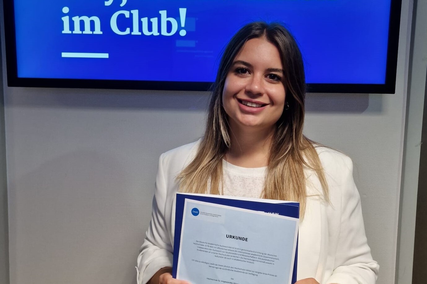 
                Female student with certificate
            