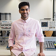 
                                Male student standing in an engineering lab
                            