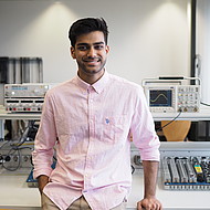 
                                Male student standing in an engineering lab
                            