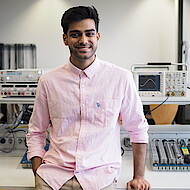 
                                Male student standing in an engineering lab
                            