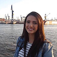 
                                Female student standing at the container port
                            