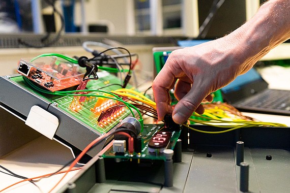 
                                Eine Hand bedient einen Regler einer Aufbaute
                            