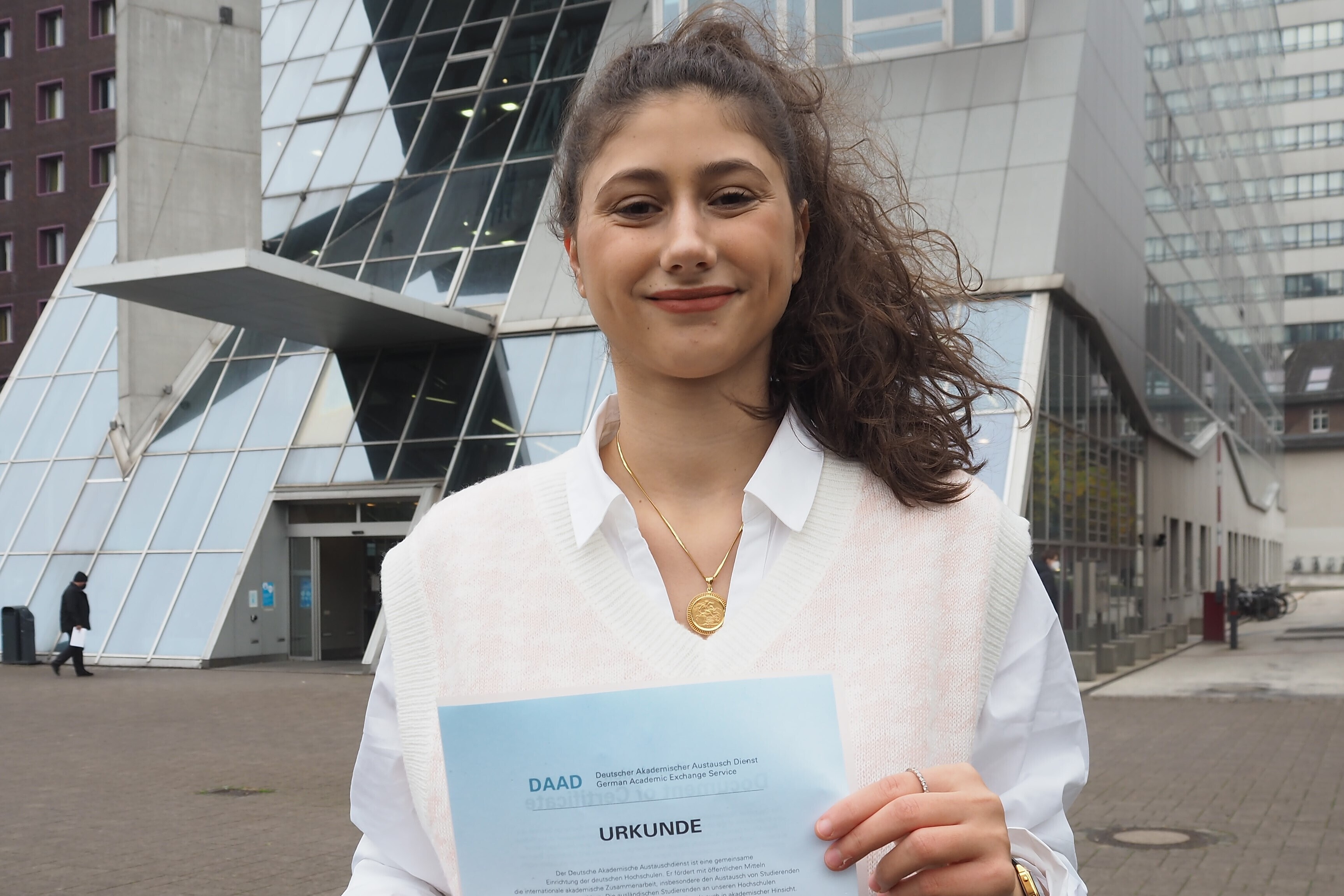 
                Female student holding a certificate
            