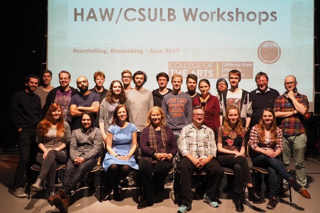 Group of people sitting in front of a video screen